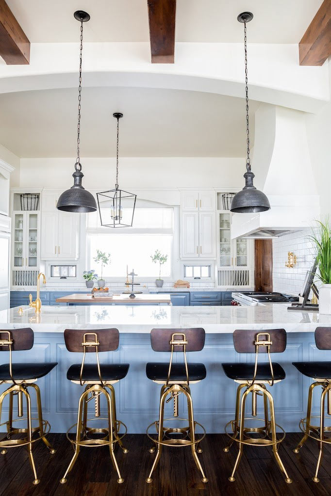 Kitchen with brass counter-height chairs